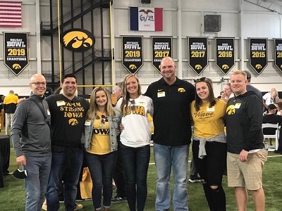 Jordan Loperena standing with a group of people at a pre-game event