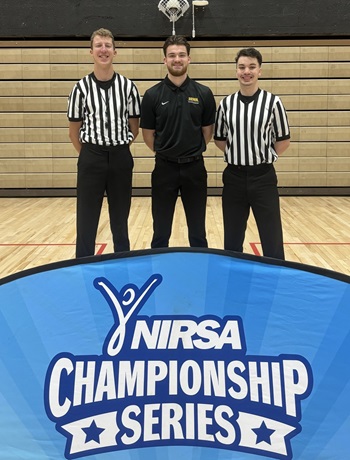 Alex Tuttle with basketball officials.