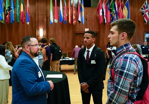 Networking conversation at symposium.