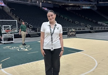 Taylor Ciabatti on Milwaukee Bucks basketball court.