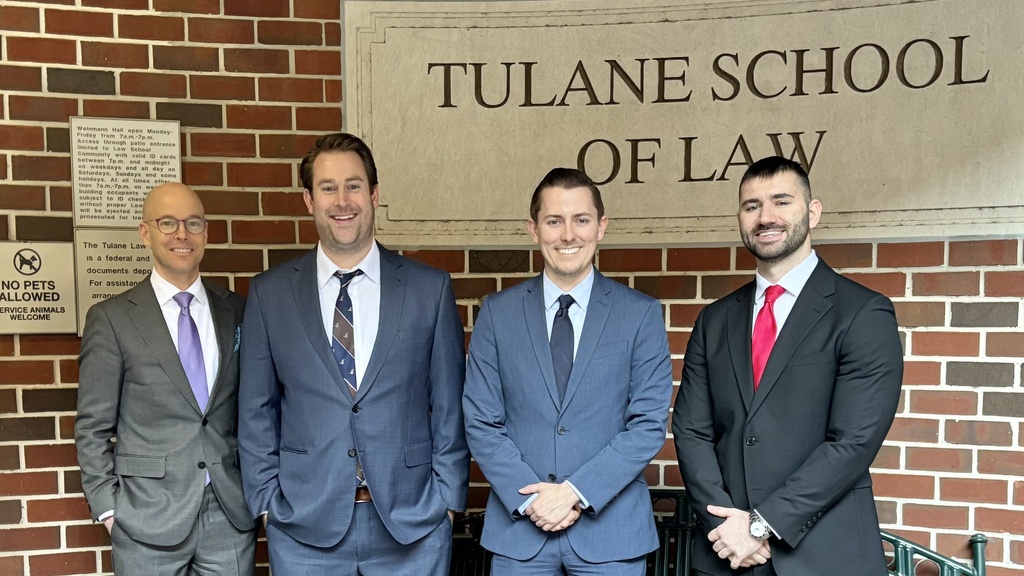 Dan Matheson with students in front of Tulane building